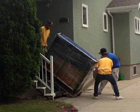 moose movers team moving couch downstairs